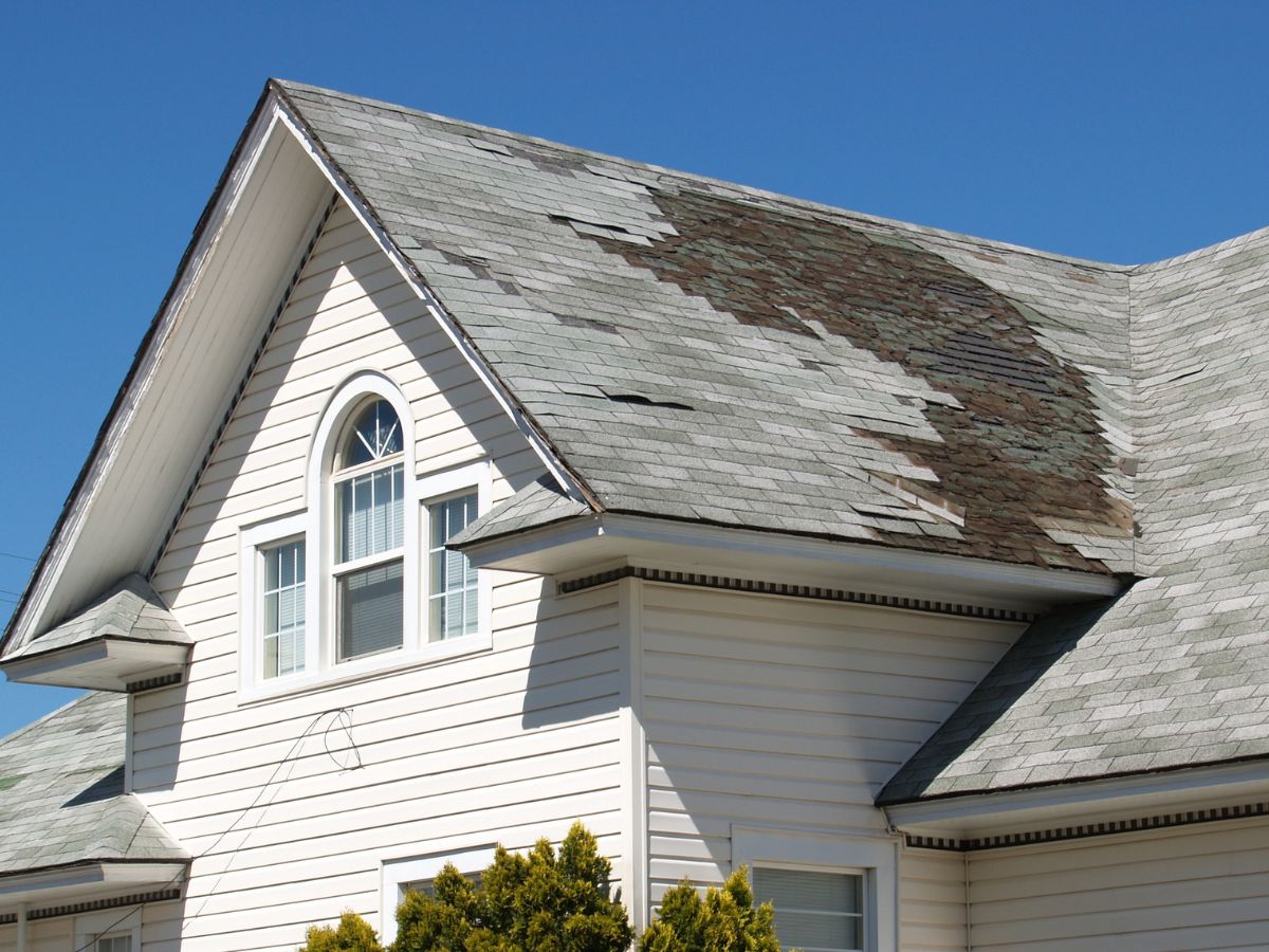 Damaged shingles on the house need roof repair
